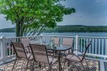 Outdoor dining area on the deck with view of the lake